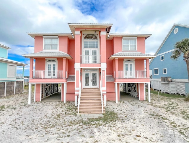 2210 W Beach Blvd, Gulf Shores, AL 36542 - raised beach house with metal roof, stucco siding, and french doors