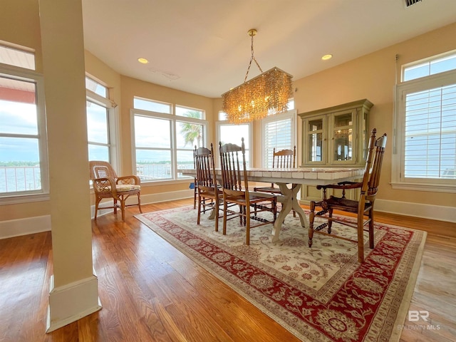 2210 W Beach Blvd, Gulf Shores, AL 36542 - dining room featuring a notable chandelier, baseboards, and a wealth of natural light
