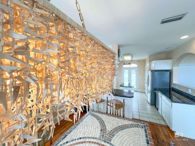 2210 W Beach Blvd, Gulf Shores, AL 36542 - dining space featuring visible vents, french doors, and light wood-type flooring