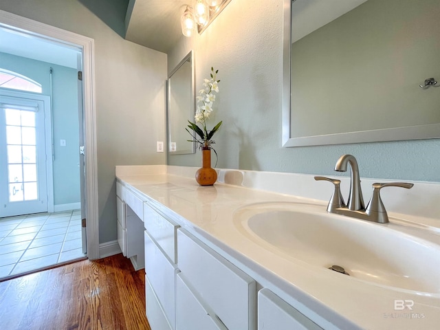 2210 W Beach Blvd, Gulf Shores, AL 36542 - bathroom featuring baseboards, wood finished floors, and vanity