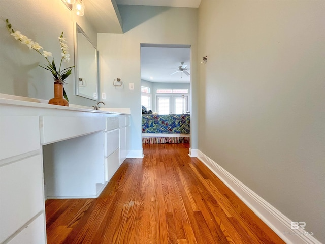 2210 W Beach Blvd, Gulf Shores, AL 36542 - hall featuring baseboards, wood finished floors, and a sink