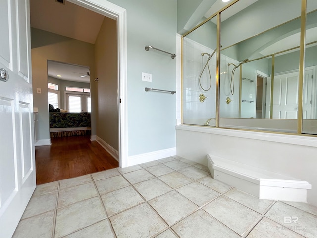 2210 W Beach Blvd, Gulf Shores, AL 36542 - ensuite bathroom with tile patterned floors, a stall shower, ensuite bath, and baseboards