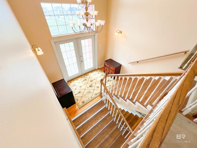 2210 W Beach Blvd, Gulf Shores, AL 36542 - foyer with french doors, a towering ceiling, a notable chandelier, and stairs