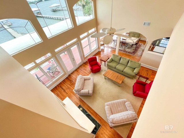 2210 W Beach Blvd, Gulf Shores, AL 36542 - living area featuring visible vents, baseboards, a towering ceiling, wood finished floors, and ceiling fan