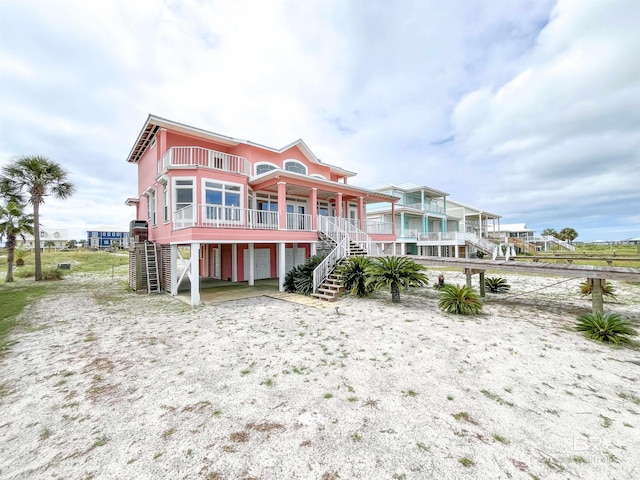 2210 W Beach Blvd, Gulf Shores, AL 36542 - rear view of house with a balcony and stairs