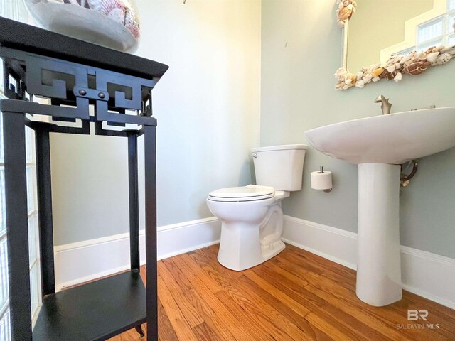 2210 W Beach Blvd, Gulf Shores, AL 36542 - bathroom with toilet, wood finished floors, and baseboards