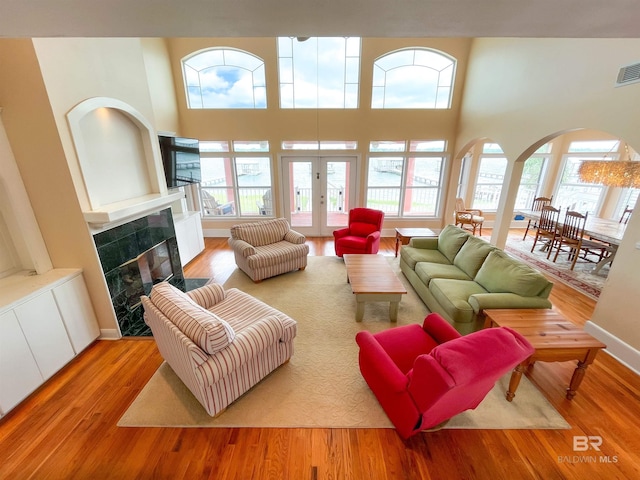 2210 W Beach Blvd, Gulf Shores, AL 36542 - living area with a high ceiling, wood finished floors, a tile fireplace, and a healthy amount of sunlight