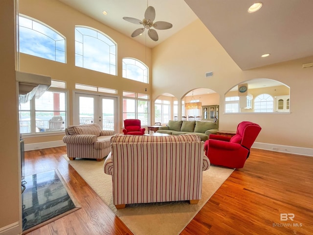 2210 W Beach Blvd, Gulf Shores, AL 36542 - living room with arched walkways, baseboards, ceiling fan, and wood finished floors