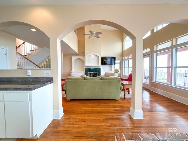 2210 W Beach Blvd, Gulf Shores, AL 36542 - living room with stairway, baseboards, a towering ceiling, a ceiling fan, and wood finished floors