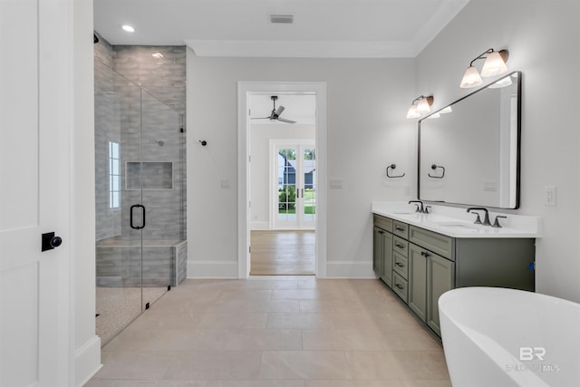 926 Inlet Cir, Gulf Shores, AL 36542 - full bath with double vanity, ceiling fan, a freestanding tub, a stall shower, and tile patterned floors