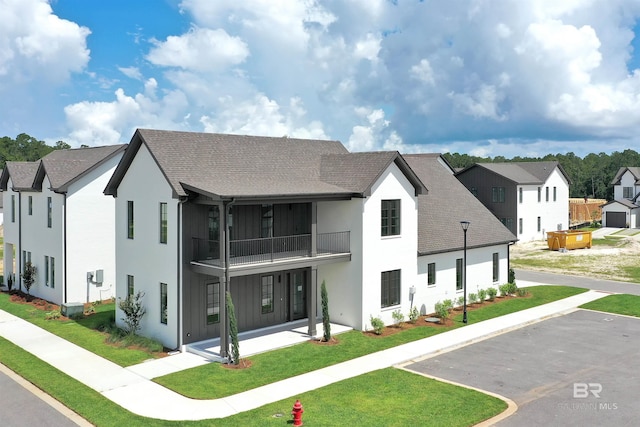 926 Inlet Cir, Gulf Shores, AL 36542 - rear view of property with a balcony, a lawn, roof with shingles, and stucco siding