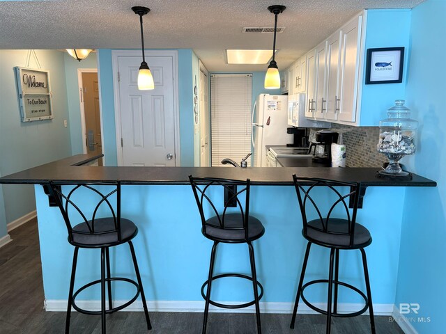 505 E Beach Blvd Unit 5-C, Gulf Shores, AL 36542 - bedroom with a textured ceiling, ornamental molding, and dark wood-style floors