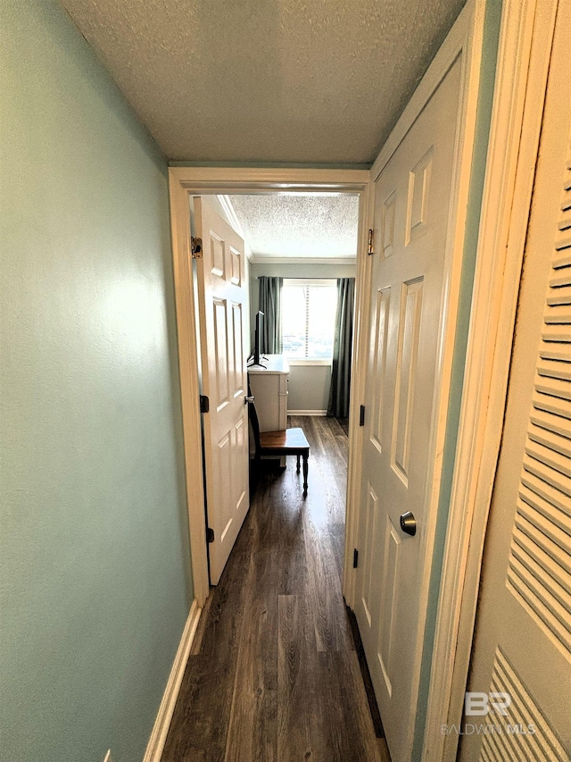 hall featuring wood-type flooring and a textured ceiling