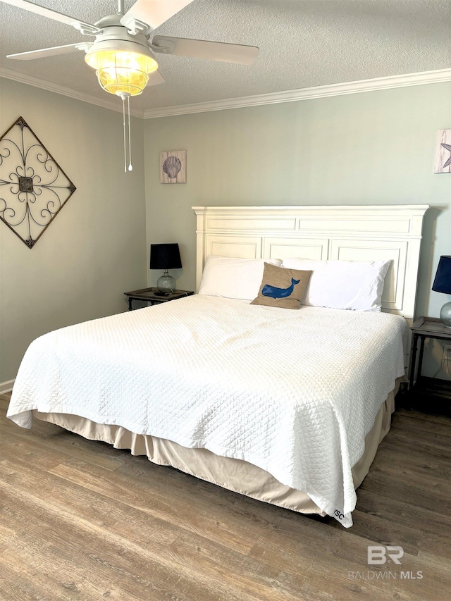 bedroom featuring ceiling fan, a textured ceiling, hardwood / wood-style floors, and crown molding