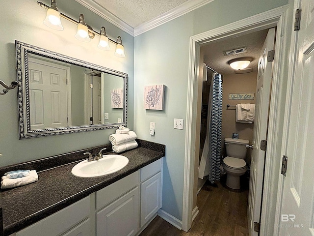 full bathroom featuring hardwood / wood-style floors, crown molding, toilet, vanity, and shower / bathtub combination with curtain