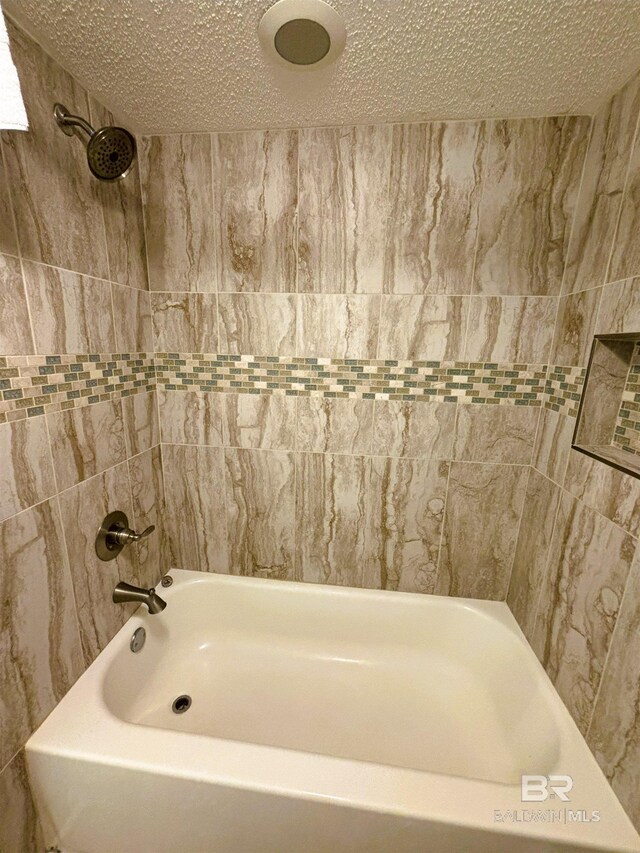 505 E Beach Blvd Unit 5-C, Gulf Shores, AL 36542 - bathroom with a textured ceiling and  shower combination
