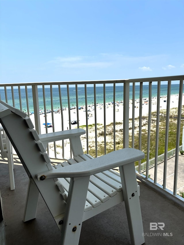 balcony with a water view and a beach view