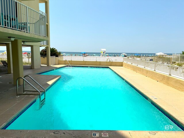 505 E Beach Blvd Unit 5-C, Gulf Shores, AL 36542 - community pool with fence, a patio area, and a water view