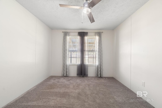 empty room with carpet flooring, ceiling fan, and a textured ceiling