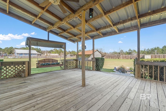 wooden terrace featuring fence and a lawn