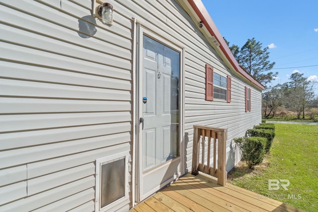 entrance to property with a lawn