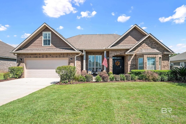 craftsman house with a garage and a front lawn