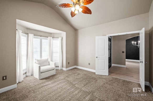 unfurnished room featuring ceiling fan, carpet floors, and vaulted ceiling