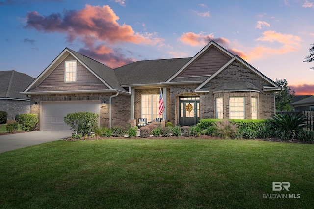 view of front of house featuring a yard and a garage