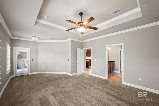 unfurnished bedroom featuring ceiling fan, light colored carpet, and a raised ceiling