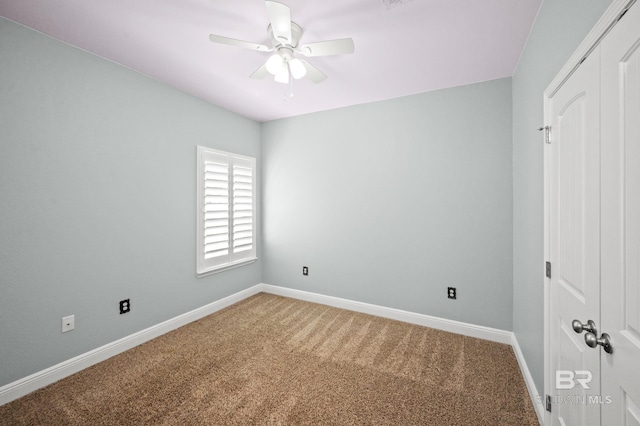 unfurnished bedroom with ceiling fan and carpet