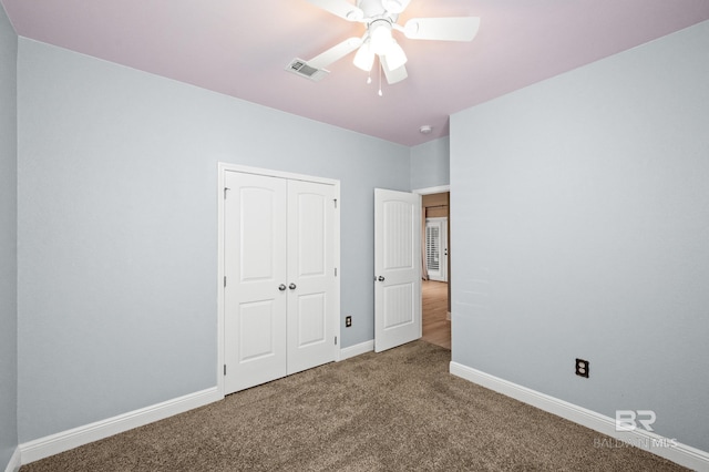 unfurnished bedroom with a closet, carpet, and ceiling fan