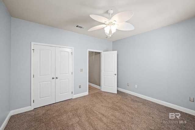 unfurnished bedroom featuring carpet flooring, ceiling fan, and a closet