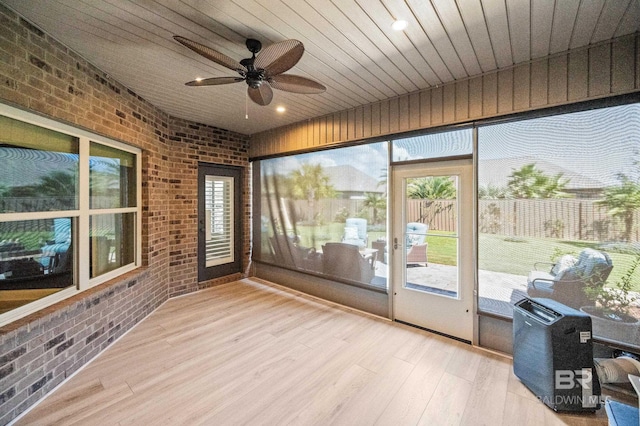 sunroom featuring ceiling fan and wooden ceiling