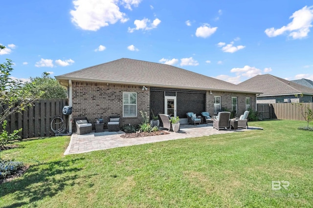 back of property with an outdoor living space, a yard, and a patio