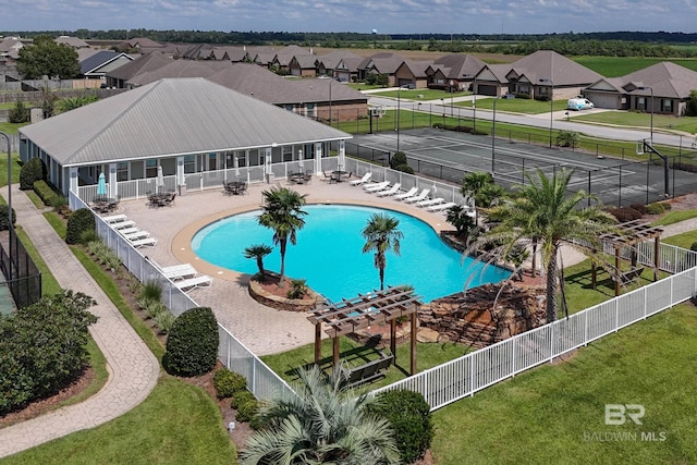 view of pool with a patio and a yard