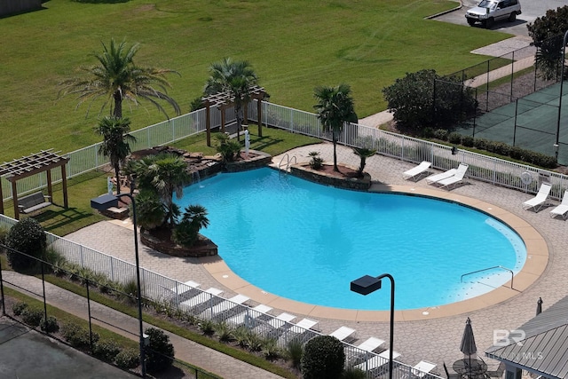 view of pool featuring a lawn and a patio