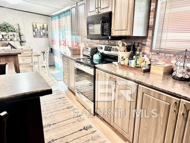 kitchen featuring backsplash, light wood-type flooring, and electric stove