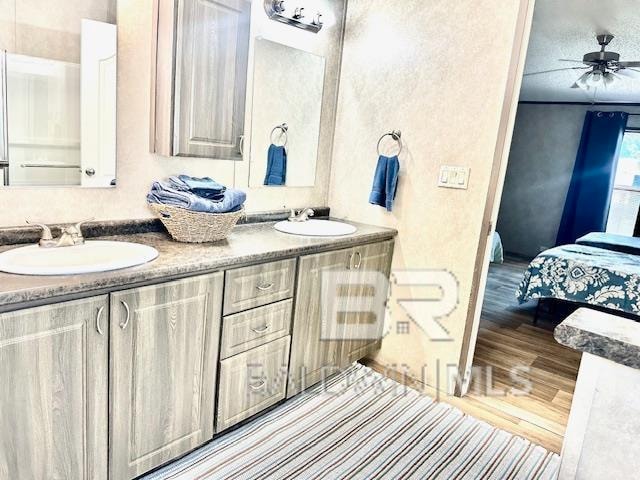 bathroom featuring vanity, ceiling fan, and hardwood / wood-style flooring