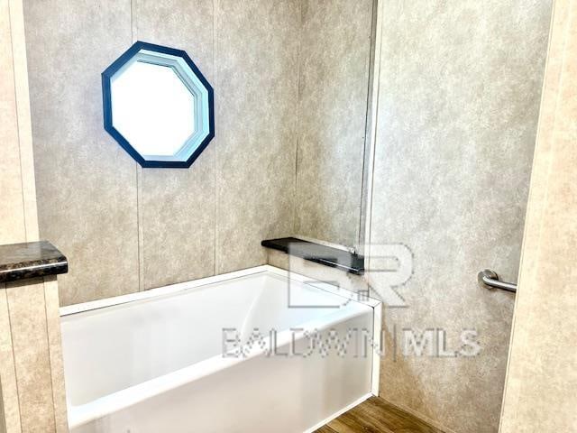 bathroom featuring a tub and wood-type flooring