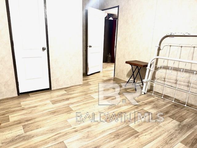 unfurnished bedroom with light wood-type flooring