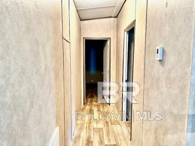 corridor with light hardwood / wood-style floors