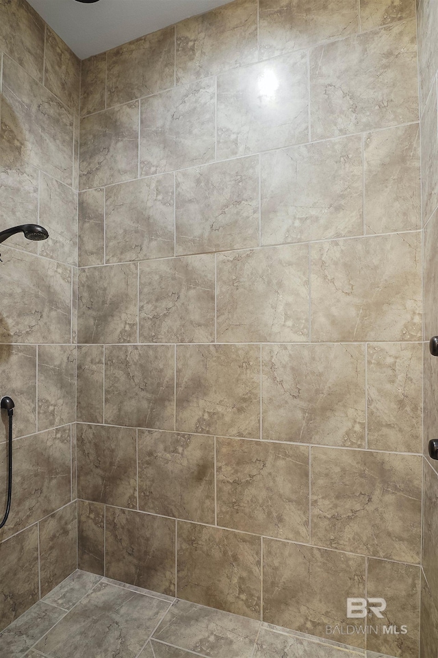 bathroom with a tile shower