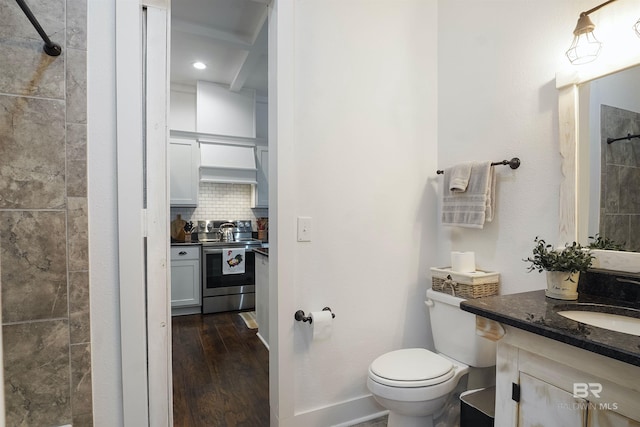 bathroom featuring tiled shower, toilet, wood-type flooring, vanity, and decorative backsplash