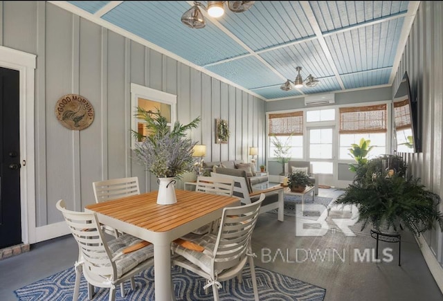 sunroom / solarium featuring ceiling fan and a wall unit AC