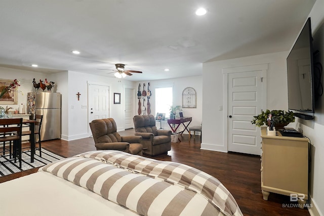 living room with ceiling fan and dark hardwood / wood-style flooring