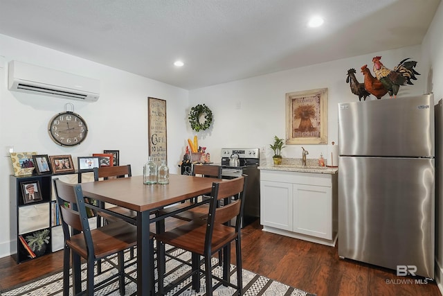 dining space with dark hardwood / wood-style flooring, sink, and a wall unit AC