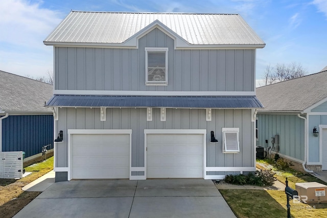 view of front facade featuring a garage and central AC