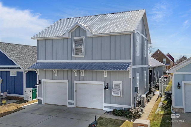 view of front of home featuring a garage and central air condition unit