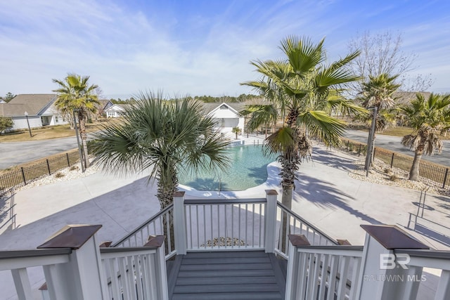 exterior space with a fenced in pool and a patio