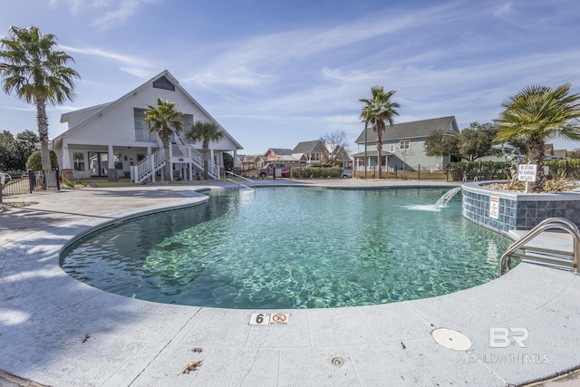 view of swimming pool with a patio area and pool water feature